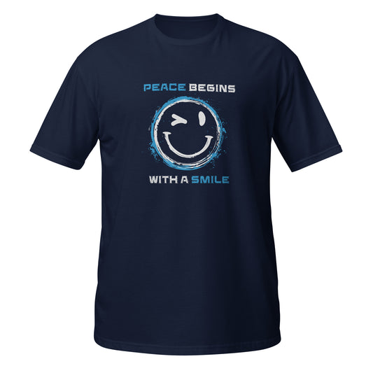 Navy Unisex‑T‑Shirt mit großem gelbem Smiley, blauem Kreis und dem Schriftzug „Peace Begins With a Smile“.

